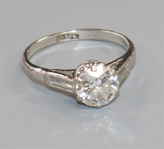 A mid 20th century platinum and single stone diamond ring with diamond set shoulders, size N.